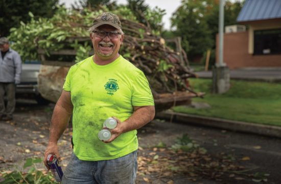 Camas Lions Club member Brian Scott takes a break to smile during his clubs’ clean up at the Inter-Faith Treasure House in Washougal. PHOTO BY JACOB GRANNEMAN