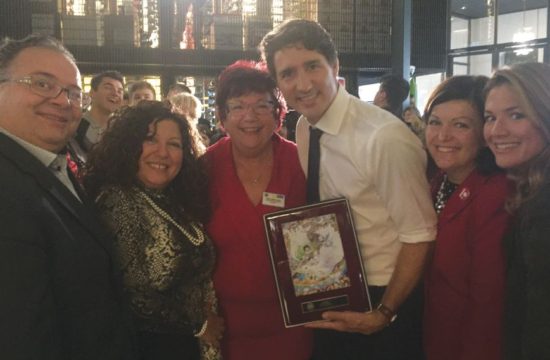 (Left to right) Canadian Member of Parliament (MP) Ramez Ayoub, New Voices Coordinator Liliane Farhat, PDG Nicole LePage, Prime Minister Justin Trudeau, MP Linda Lapointe, and Madame Sophie Grégoire Trudeau pose with the Prime Minister's new Lions Clubs Peace plaque.