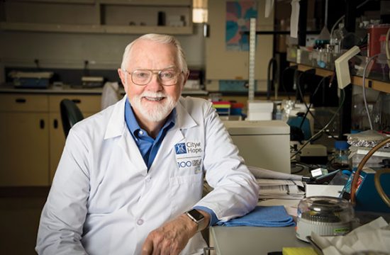 Dr. Riggs in lab coat.