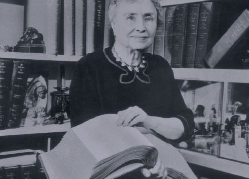 A 1956 portrait of Helen Keller holding a Braille volume. Lessons about Helen Keller have been put back into the Texas state curriculum. PHOTO BY HULTON ARCHIVE/GETTY IMAGES