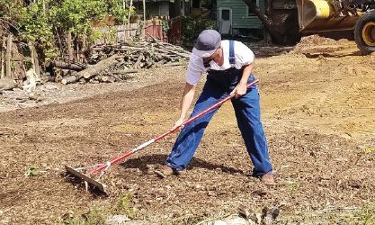 Lion Gregory Sheldon works to spread woodchips at the site.