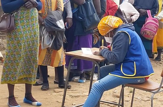 Lions Club member checks in woman for vaccine
