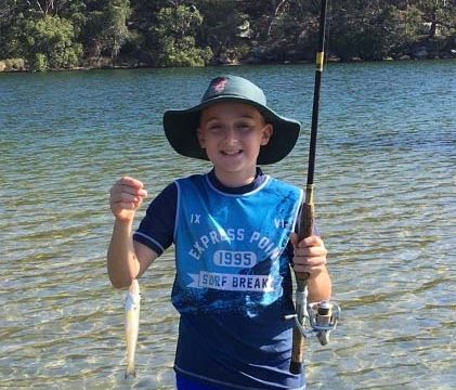 Boy holding fish he caught